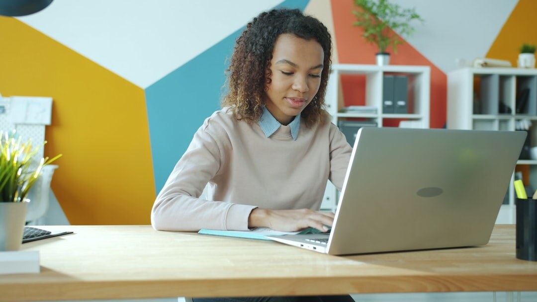 Person working on laptop in a bright modern office